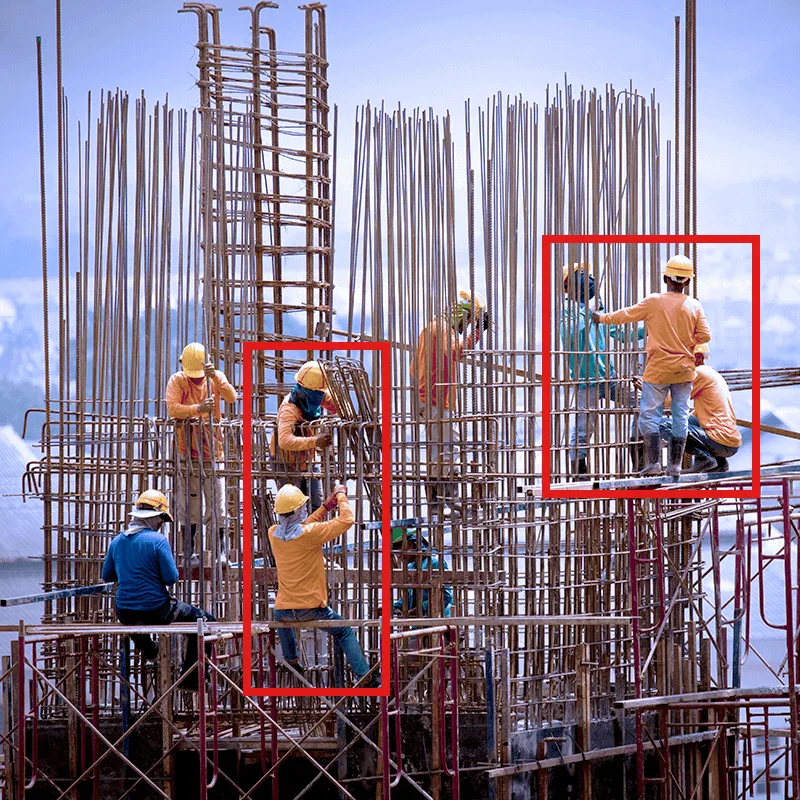 Construction workers assembling reinforced concrete framework on active job site