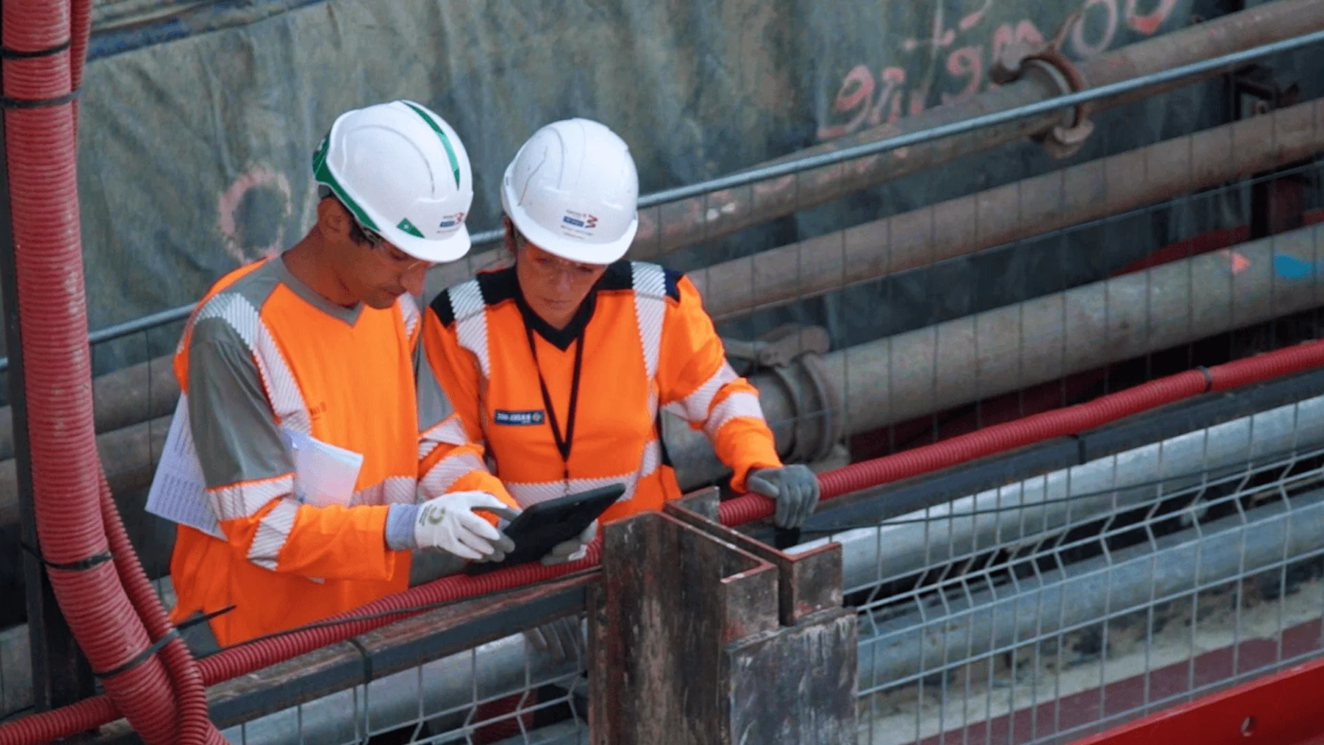 Team reviewing specifications on Novade tablet during Grand Paris Metro underground construction