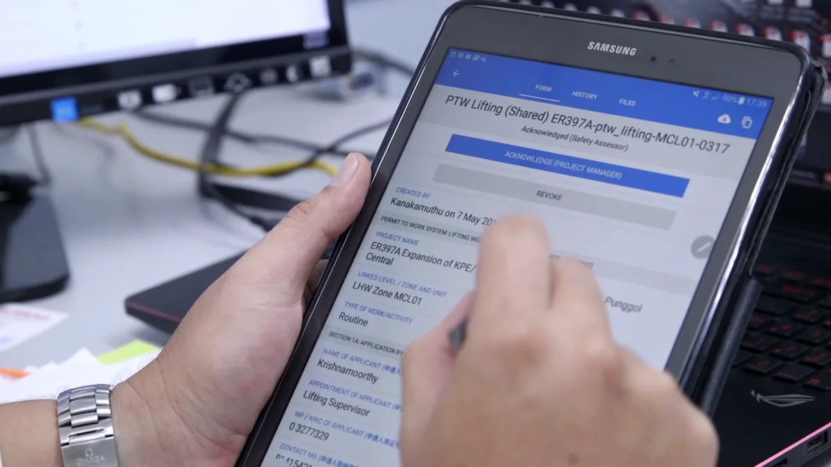 Worker accessing safety permit-to-work on Novade construction tablet